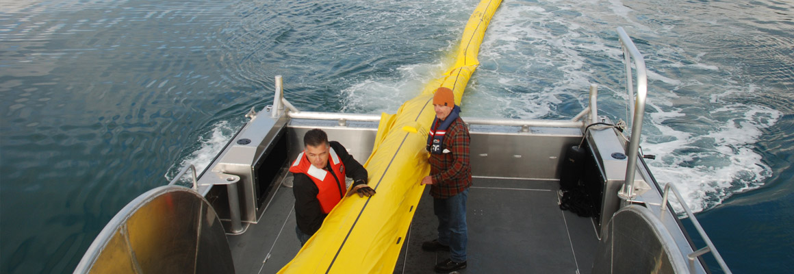 Workers practice boom deployment for an oil spill drill near El Segundo, California